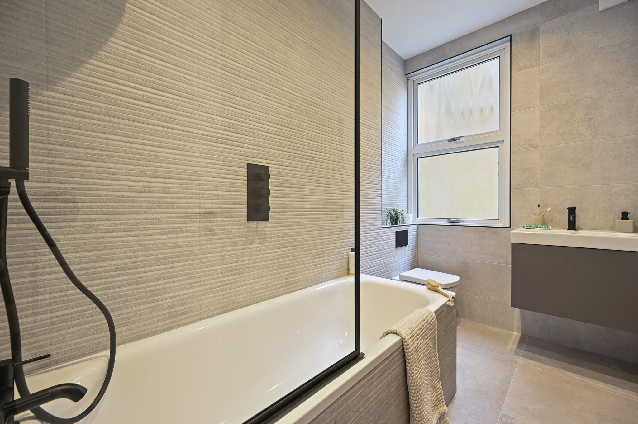Open-plan reception and kitchen of the refurbished flat at Larden Road, Acton W3