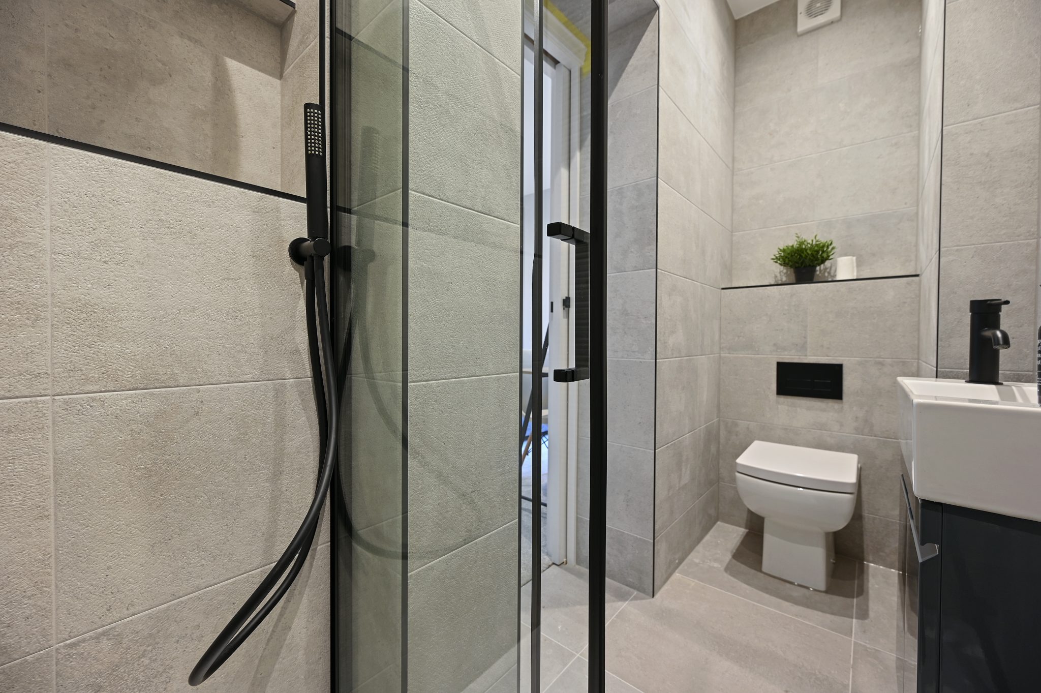 Open-plan reception and kitchen of the refurbished flat at Larden Road, Acton W3