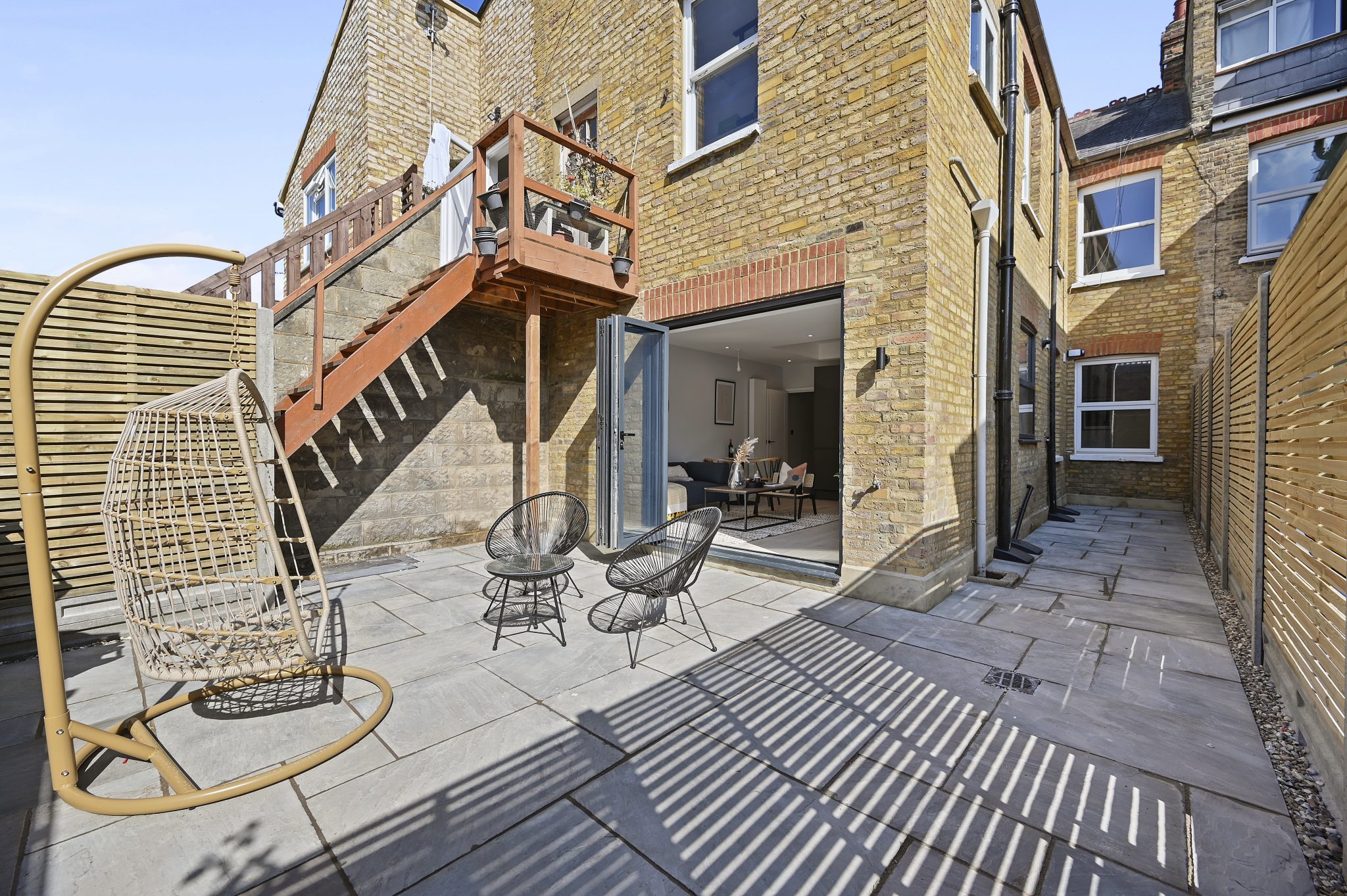 Open-plan reception and kitchen of the refurbished flat at Larden Road, Acton W3