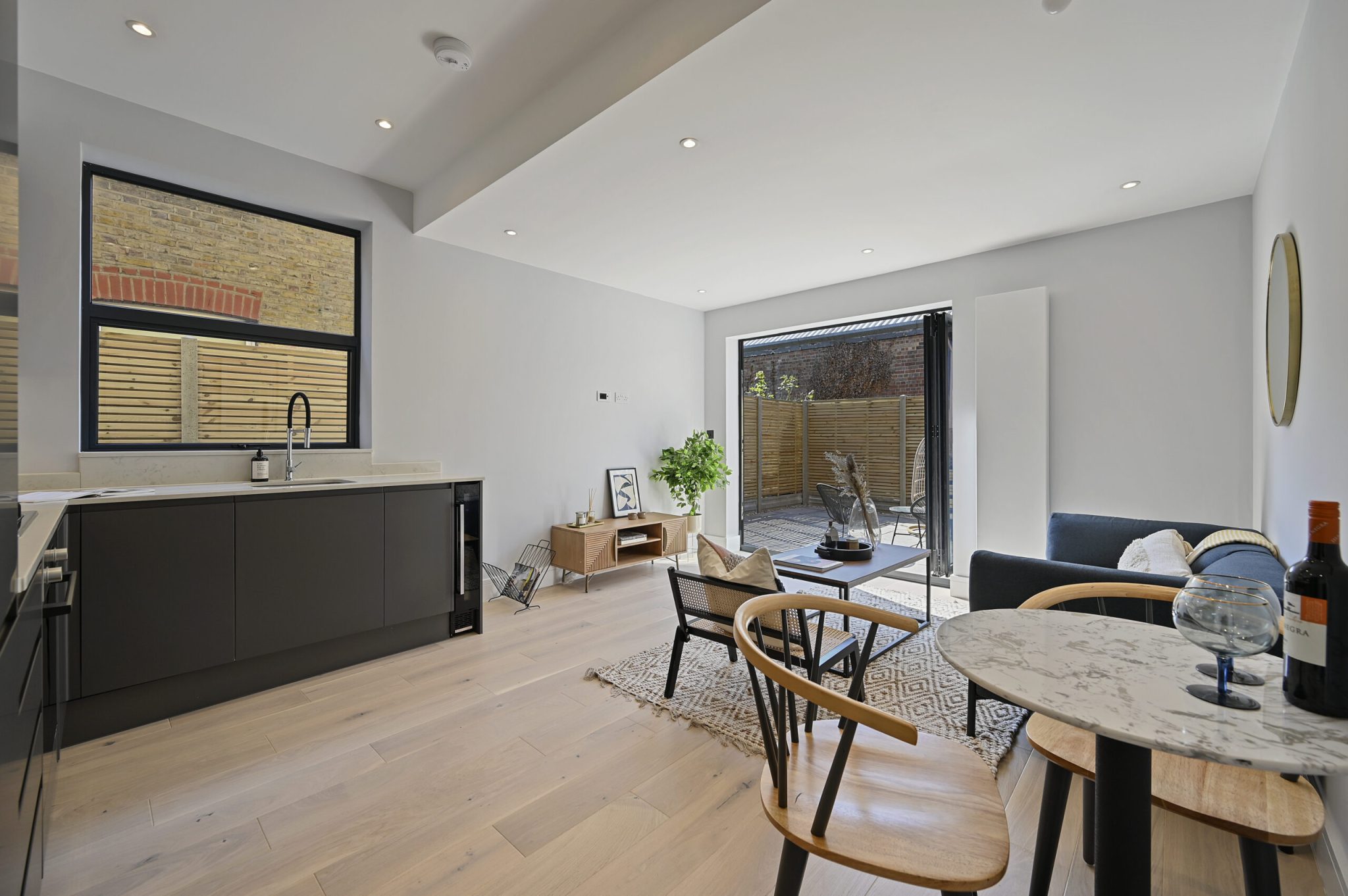 Open-plan reception and kitchen of the refurbished flat at Larden Road, Acton W3