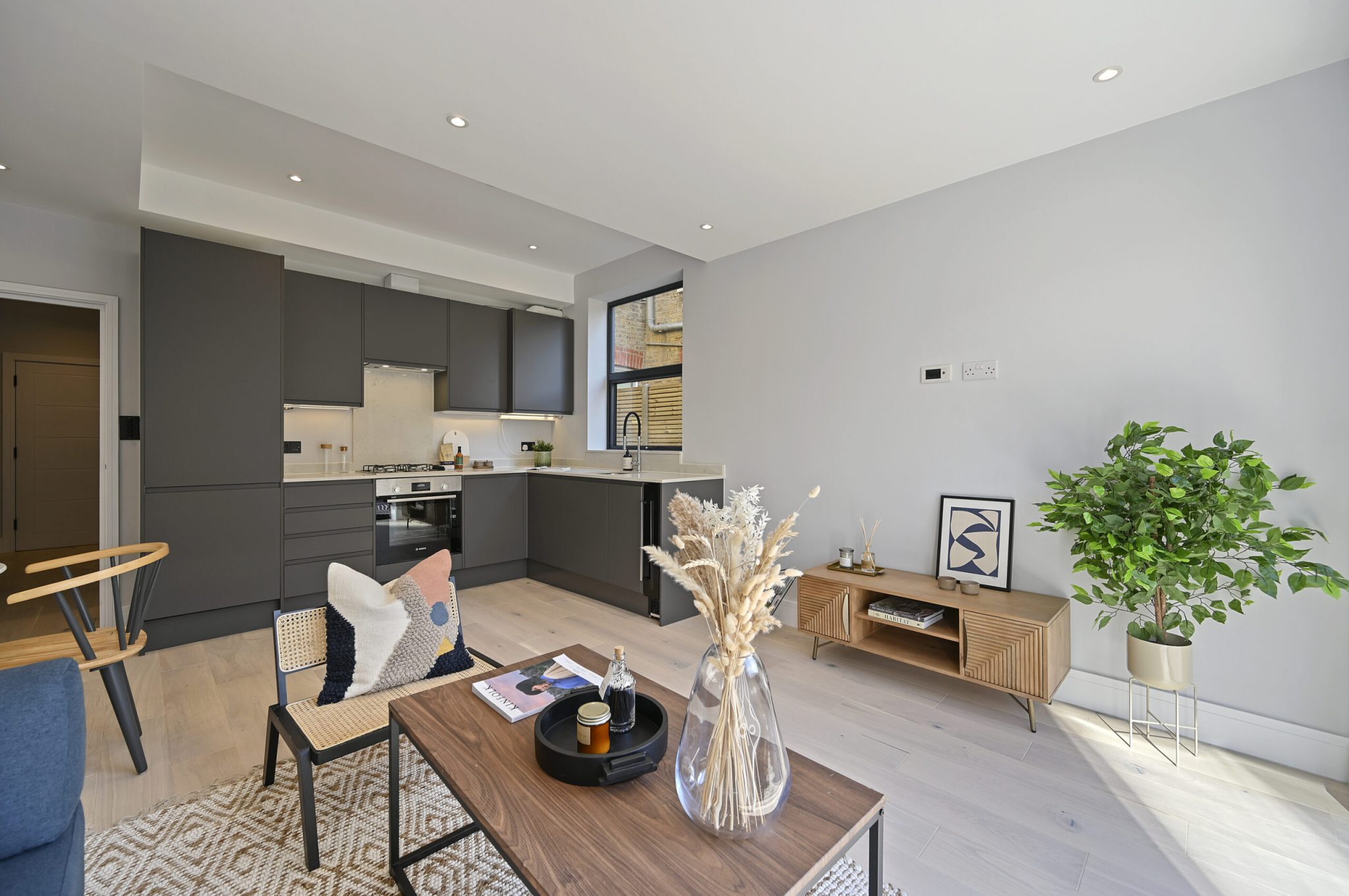 Open-plan reception and kitchen of the refurbished flat at Larden Road, Acton W3