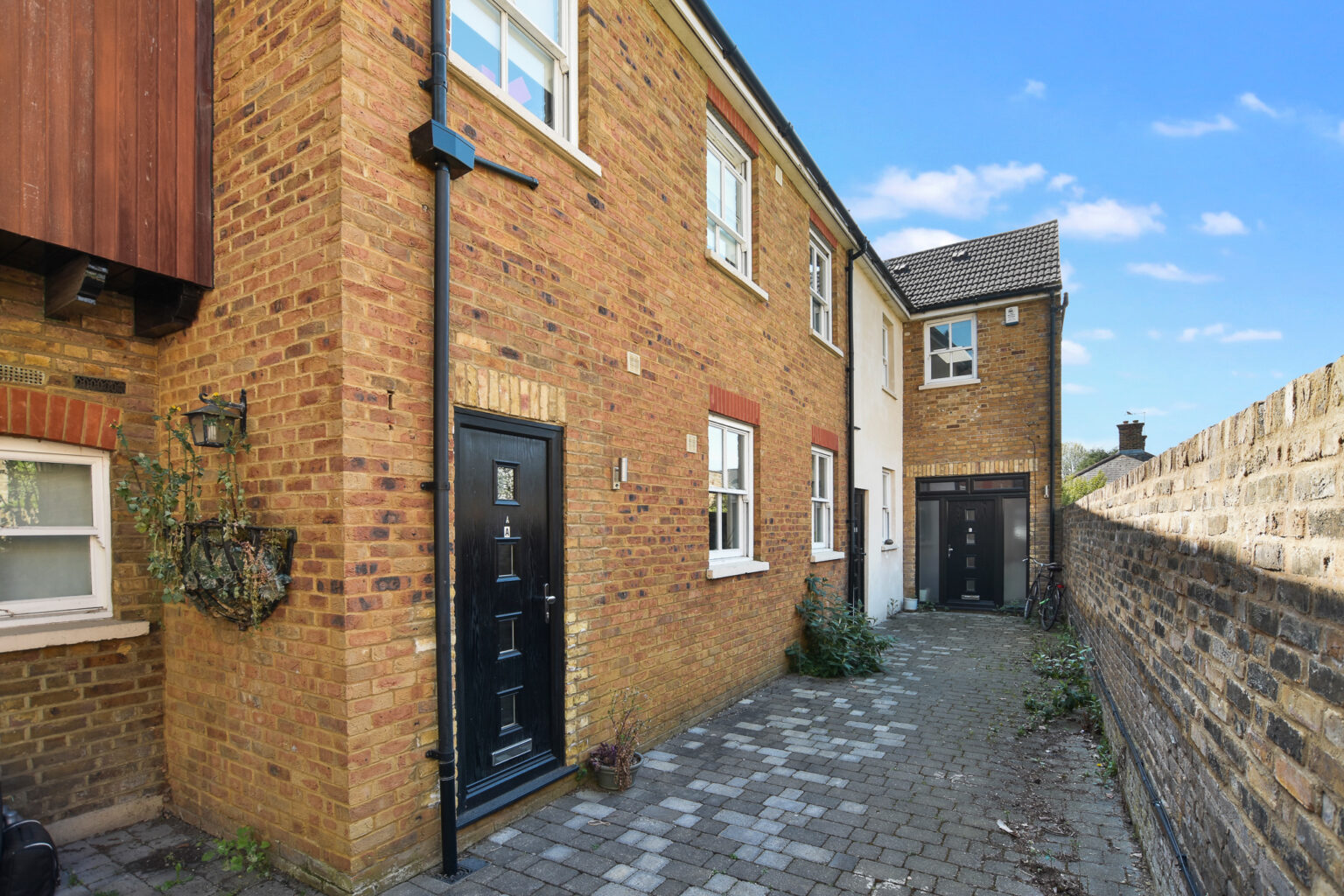 Exterior of the Station Road scheme in Hampton, a mixed-use building converted into five flats and a commercial unit
