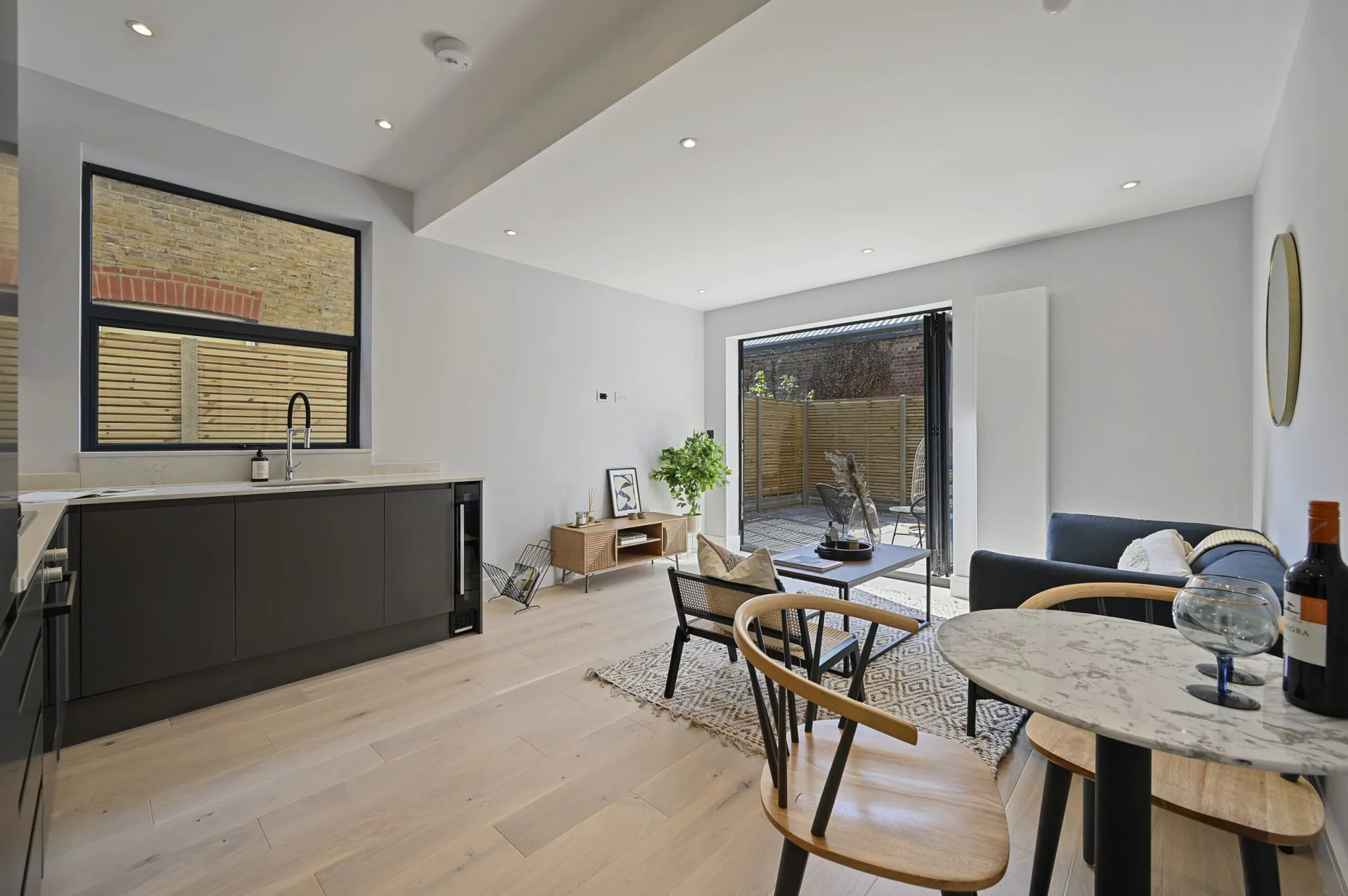 Open-plan reception and kitchen of the refurbished flat at Larden Road, Acton W3